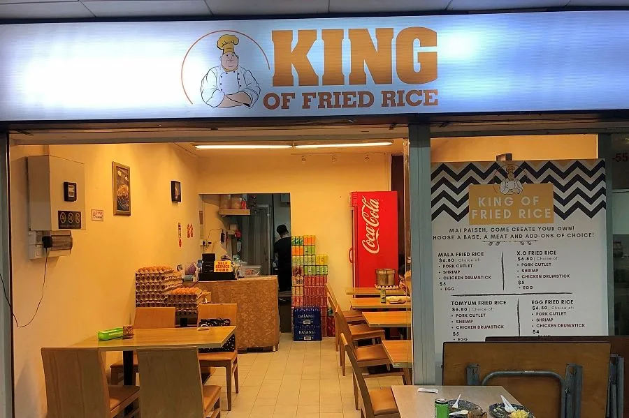 The original King of Fried Rice shopfront at Golden Mile Tower, with the chef-mascot signboard and a hand-lettered menu board