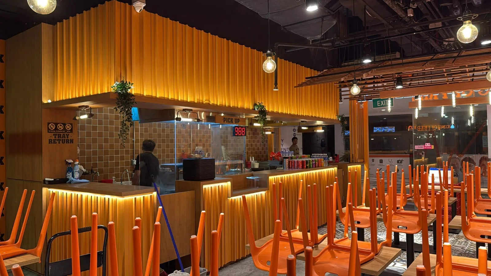 The pick-up counter and queue-number display at a King of Fried Rice restaurant-format outlet