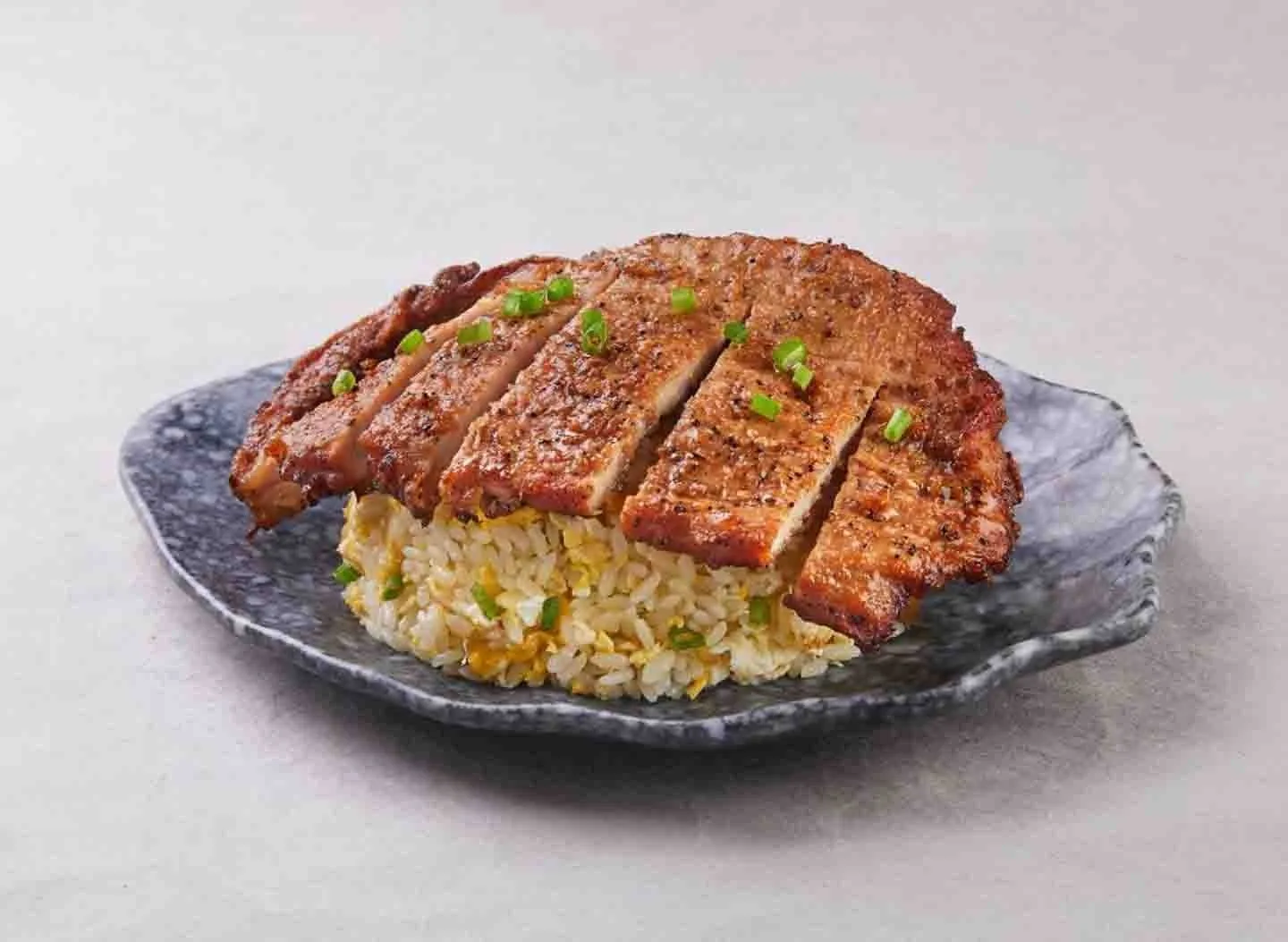 Pork cutlet egg fried rice on the King of Fried Rice speckled ceramic plate